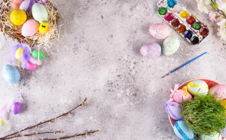 Easter eggs in a grass nest, homemade iced cookies, and paints for painting eggs and grass