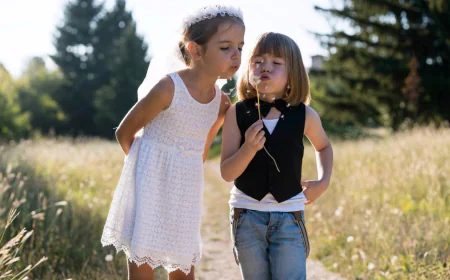 Two friends whimsically blowing dandelions together photo free download