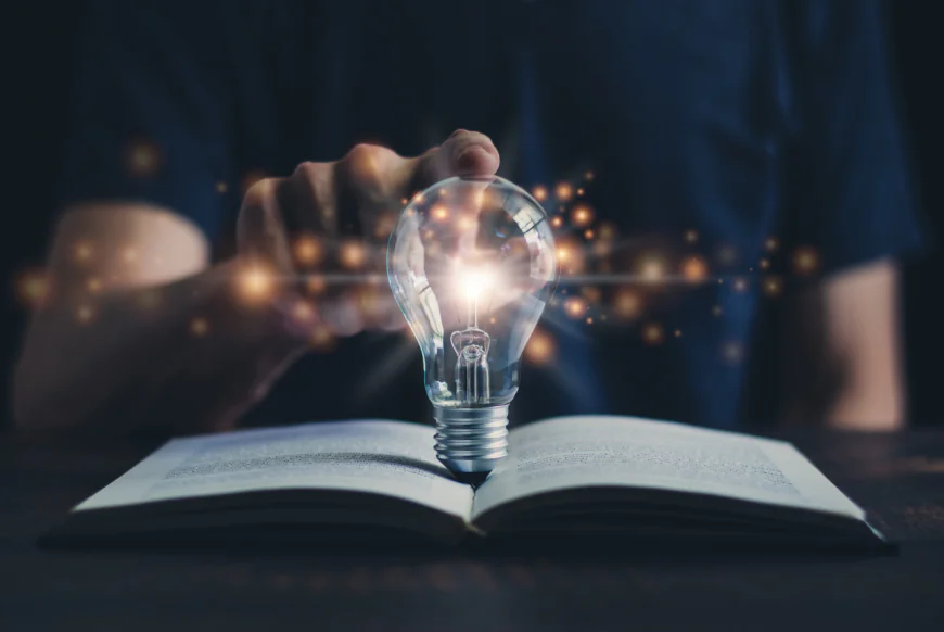 Photo of lightbulb on book, concept of knowledge free download