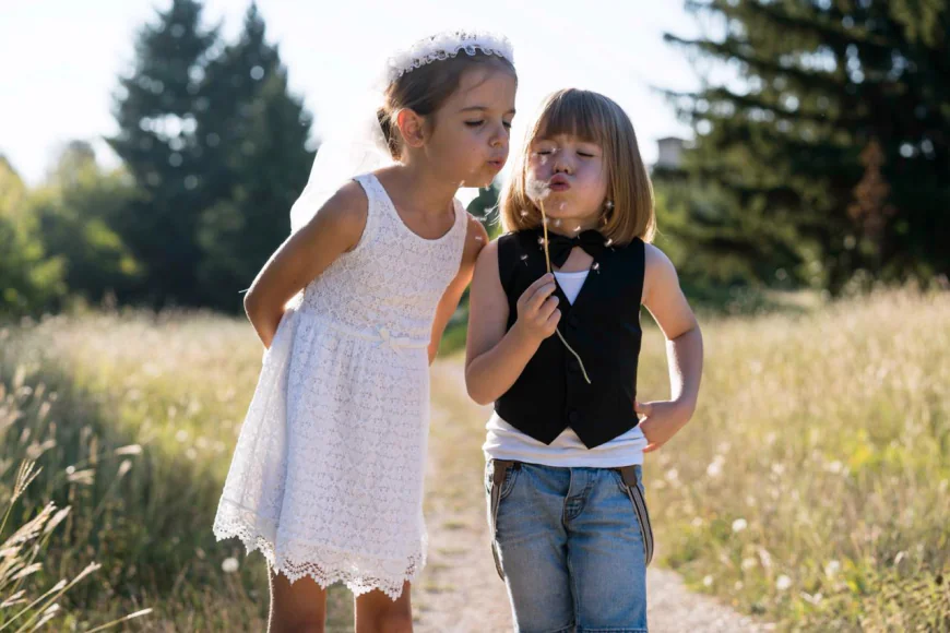 Two friends whimsically blowing dandelions together photo free download
